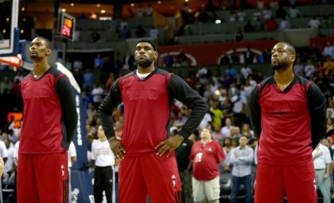 CHARLOTTE, NC - APRIL 28: Chris Bosh #1 of the Miami Heat stands alongside teammates LeBron James #6 and Dwyane Wade #3 while wearing inside out warm up jerseys before playing the Charlotte Bobcats in Game Four of the Eastern Conference Quarterfinals during the 2014 NBA Playoffs at Time Warner Cable Arena on April 28, 2014 in Charlotte, North Carolina. NOTE TO USER: User expressly acknowledges and agrees that, by downloading and or using this photograph, User is consenting to the terms and conditions of the Getty Images License Agreement. Streeter Lecka/Getty Images/AFP