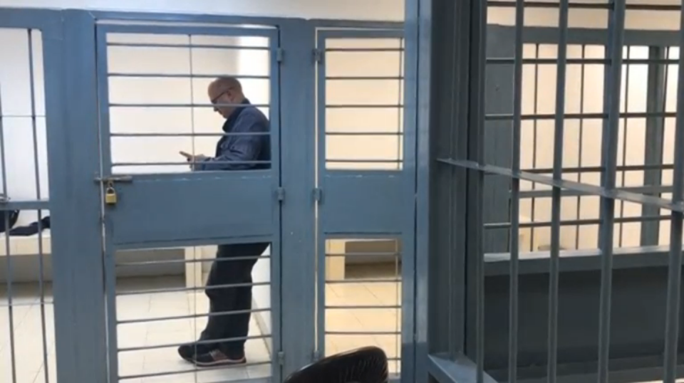 A British journalist was charged with arms possession on Tuesday (May 30), police said, after he was arrested at an airport in the Thai capital for checking in body armor plates and gas masks as load luggage. Photo grabbed from Reuters video file.