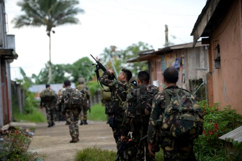 Philippine soldiers patrol a deserted neighbourhood as they search for Islamist militants in Marawi on the southern island of Mindanao on May 26, 2017.  Foreigners are among Islamist gunmen battling security forces in a southern Philippine city, the government said May 26 as the reported death toll from four days of clashes climbed to 46. / AFP PHOTO / TED ALJIBE