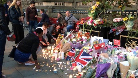 People bring flowers in tribute to the victims of the Manchester Arena blast that claimed young lives.  (Eagle News Service, EBC London Bureau photo)