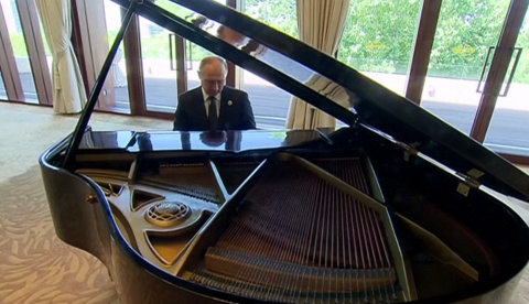 Russian President Vladimir Putin is seen here playing on a grand piano while waiting to meet Chinese President Xi Jinping in Beijing on Sunday. (Photo grabbed from AFP video) 