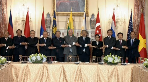 U.S. Secretary of State Rex Tillerson along with ASEAN leaders linking hands in a large conference hall for a photo opportunity.  (Photo grabbed from Reuters video) 