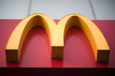 A McDonald's fast food restaurant sign is seen in Beijing on January 9, 2017. US fast-food giant McDonalds will sell a controlling stake in its China and Hong Kong business for up to 2.08 billion USD to a consortium including state-owned Citic and the Carlyle Group, it was announced on January 9. McDonald's has ended its longtime Olympic sponsorship dating back to 1976, the International Olympic Committee announced on Friday./ AFP PHOTO / NICOLAS ASFOURI