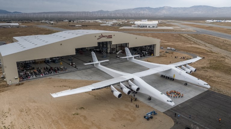 The Stratolaunch plane is pushed out of the hanger for the first time in the Mojave desert, California on May 31, 2017. A colossal rocket-launching plane touted as the future of space travel is closer to testing, having been rolled out of a hangar in the desert, its creators said. The project backed by billionaire Microsoft co-founder Paul Allen has been proceeding for about six years and was on track for its first launch demonstration as early at 2019, Stratolaunch Systems Corporation chief executive Jean Floyd said in a blog post. / AFP PHOTO / Stratolaunch Systems Corp / April Keller / RESTRICTED TO EDITORIAL USE - MANDATORY CREDIT "AFP PHOTO / Stratolaunch Systems Corp/ April Keller" - NO MARKETING NO ADVERTISING CAMPAIGNS - DISTRIBUTED AS A SERVICE TO CLIENTS