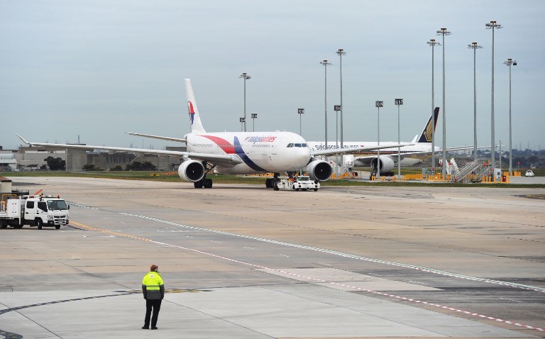 A plane believed to be Malaysia Airlines flight MH128 returns from the hangers following its forced return in Melbourne on June 1, 2017. Armed police stormed a Malaysia Airlines flight which was forced to return to Melbourne after a passenger tried to enter the cockpit claiming he had a bomb, officials said on June 1, 2017. / AFP PHOTO / Mal Fairclough