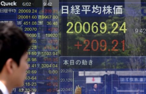 A man looks at a stock quotation board flashing the key Nikkei index of the Tokyo Stock Exchange in front of a securities company in Tokyo on June 2, 2017. Tokyo shares opened higher June 2 after a record close on Wall Street following a batch of mostly strong economic data that raised expectations for a looming US jobs report. / AFP PHOTO / Kazuhiro NOGI