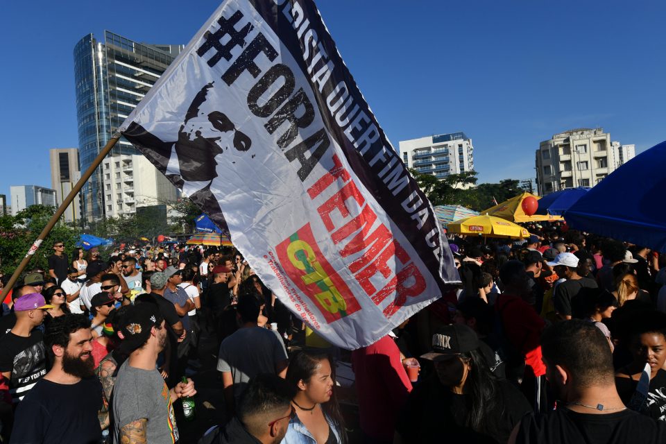 Demonstrators protest against labor and security reforms and the government of President Michel Temer in Sao Paulo Brazil on June 4, 2017. Brazil's Michel Temer may already be fighting a devastating corruption scandal, but this week he will face a more immediate threat: a court ruling on whether he should even be president. The Supreme Electoral Tribunal (TSE) case alleges that the reelection victory in 2014 of president Dilma Rousseff and her then vice president Temer was fatally tainted by illegal campaign funds and other irregularities and therefore should be annulled. / AFP PHOTO / NELSON ALMEIDA