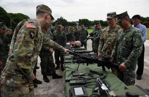Philippine Marine Commandant Major General Emmanuel Salamat (R) listens to US military representatives during a handover ceremony of weapons from the US military, at Marine headquarters in Manila on June 5, 2017. The United States on June 5 gave counterterrorism weapons to help the Philippine military fight Islamic militants, authorities said, despite tirades from President Rodrigo Duterte against arms from Washington. / AFP PHOTO / TED ALJIBE