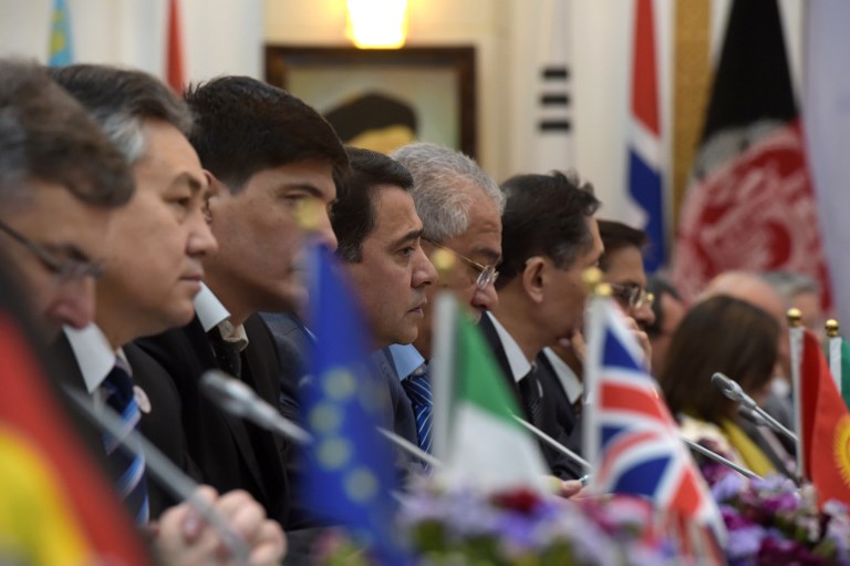 Foreign delegations listen to Afghan President Ashraf Ghani during an international peace conference at the Presidential Palace in Kabul on June 6, 2017. Afghan President Ashraf Ghani issued an ultimatum to the Taliban on June 6, warning them to embrace peace or "face consequences" after announcing that the death toll from last week's truck bombing had passed 150. / AFP PHOTO / SHAH MARAI