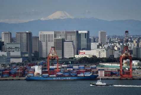 (FILES) This file picture taken on February 8, 2017 shows a freighter being anchored at the international container pier at Tokyo port, as Japan's landmark Mt.Fuji is seen in the background. Japan's economy grew less than initially thought in the first quarter, revised government data showed on June 8, 2017, but the weaker-than-expected numbers still confirmed the longest expansion in over a decade. The world's number three economy posted 0.3 percent growth between January and March -- or 1.0 percent at an annualised rate -- which was down from a preliminary 0.5 percent growth estimate. / AFP PHOTO / Kazuhiro NOGI
