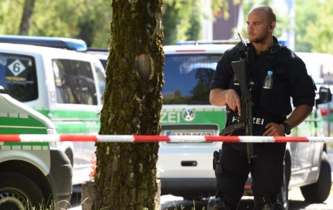 A police officer secures the area around a commuter rail station in Unterfoehring near Munich, southern Germany, where shots were fired on June 13, 2017.  According to the police, several people were injured by the shots and a female police officer was badly wounded. / AFP PHOTO / Christof STACHE