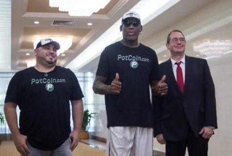 Flamboyant former NBA star Dennis Rodman (C) of the US poses with members of his party following his arrival at Pyongyang International Airport on June 13, 2017. Rodman arrived in North Korea on June 13 after saying he wants to "open the door" to the regime and claiming that US President Donald Trump would be pleased with his mission. / AFP PHOTO / Kim Won-Jin