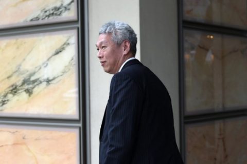 (FILES) This file photo taken on April 10, 2017 shows Lee Hsien Yang, younger brother of Singapore's prime minister Lee Hsien Loong, leaving the Supreme court on April 10, 2017 as he took the government to court for control over oral history tapes recorded by their late father, Singapore's founding leader Lee Kuan Yew. A feud between the children of Singapore's late founding leader intensified on June 14, 2017 after two siblings publicly accused their brother Prime Minister Lee Hsien Loong of disobeying their father's last wishes and abusing his powers. / AFP PHOTO / ROSLAN RAHMAN
