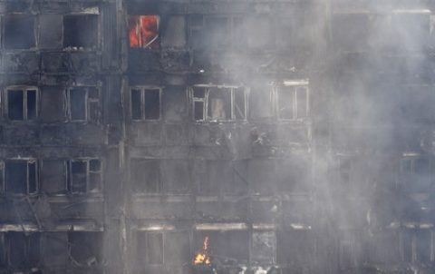 Flames and smoke engulf Grenfell Tower, a residential block on June 14, 2017 in west London.  Shaken survivors of a blaze that ravaged a west London tower block told Wednesday of seeing people trapped or jump to their doom as flames raced towards the building's upper floors and smoke filled the corridors.  / AFP PHOTO / Adrian DENNIS