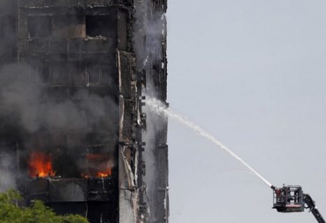 Smoke billows from Grenfell Tower as firefighters attempt to control a blaze at a residential block of flats on June 14, 2017 in west London. Shaken survivors of a blaze that ravaged a west London tower block told Wednesday of seeing people trapped or jump to their doom as flames raced towards the building's upper floors and smoke filled the corridors.  / AFP PHOTO / Adrian DENNIS