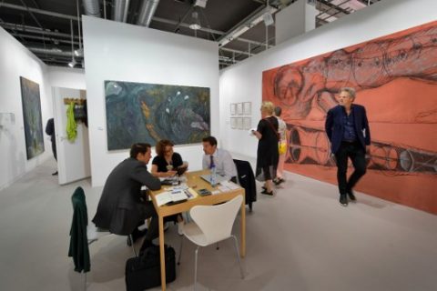 People are seen at the Bernier/Eliades Gallery's stand during the preview day of Art Basel, the world's premier modern and contemporary art fair on June 13, 2017 in Basel. Art Basel will take place to the public from June 15 to 18 in Basel. / AFP PHOTO / Fabrice COFFRINI / RESTRICTED TO EDITORIAL USE - MANDATORY MENTION OF THE ARTIST UPON PUBLICATION - TO ILLUSTRATE THE EVENT AS SPECIFIED IN THE CAPTION
