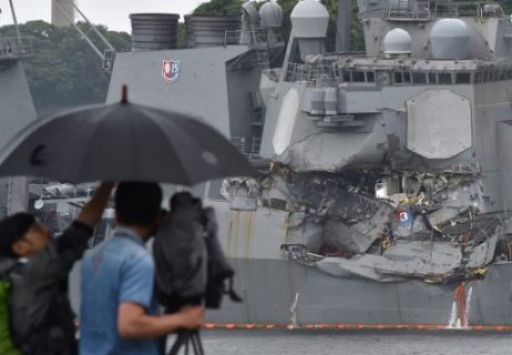 A TV crew films the damages on the guided missile destroyer USS Fitzgerald at its mother port in Yokosuka, southwest of Tokyo on June 18, 2017. A number of missing American sailors have been found dead in flooded areas of a destroyer that collided with a container ship off Japan's coast, the US Navy said on June 18, 2017. / AFP PHOTO / Kazuhiro NOGI