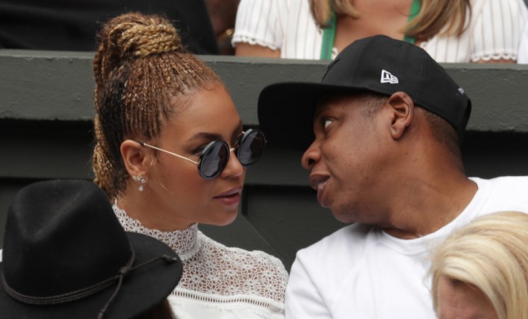 (FILES) This file photo taken on July 9, 2016 shows US singer Beyonce (L) and her husband US rapper Jay Z (R) sitting in the players box to watch Serena Williams play against Germany's Angelique Kerber during the women's singles final of the 2016 Wimbledon Championships in Wimbledon, southwest London. Pop diva Beyonce and her rap mogul husband Jay-Z have welcomed twins, according to multiple US media reports, with two new members joining music's royal family that already includes five-year-old Blue Ivy. / AFP PHOTO / POOL AND AFP PHOTO / Adam DAVY / RESTRICTED TO EDITORIAL USE