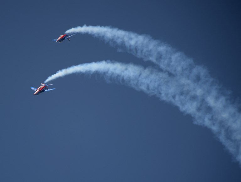 Two Patrouille de France jets perform a training aerial show in Le Bourget on June 18, 2017 on the eve of the opening of the International Paris Air Show. / AFP PHOTO / ERIC PIERMONT