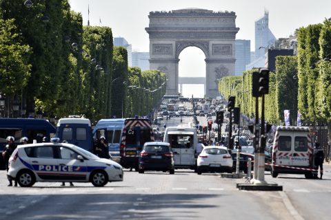 Police seal off the Champs-Elysees avenue on June 19, 2017 in Paris after a car crashed into a police van before bursting into flames, with the driver being armed, probe sources said. A source close to the investigation said the driver was "seriously injured". / AFP PHOTO / ALAIN JOCARD