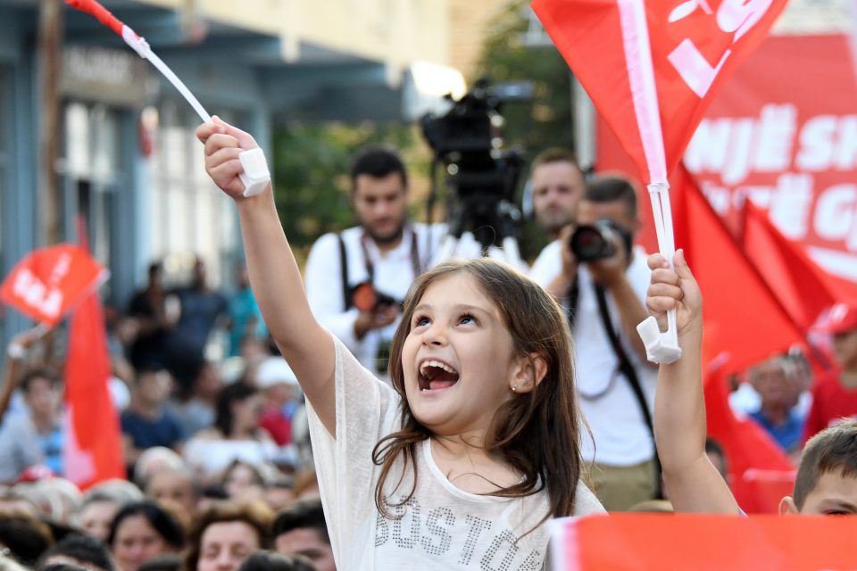 An Albanian child waves a flag during a campaign rally of the Albania's Socialist Movement for Integration (LSI) party held ahead of the upcoming general election in Kavaje on June 20, 2017. The legislative elections in Albania will take place on June 25, 2017. / AFP PHOTO / Gent SHKULLAKU