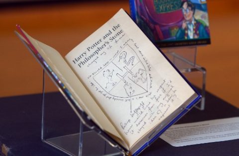 Hand-written notes by author J.K. Rowling are pictured inside a rare first edition of her book 'Harry Potter and the Philosopher's Stone'm displayed at The National Library of Scotland in Edinburgh, Scotland on June 26, 2017. Harry Potter turns 20 on Monday when muggle readers in gowns and glasses from Indonesia to Uruguay will celebrate the birth of a global publishing phenomenon in 1997. Conjured up on a 1990 train journey between Manchester and London, the saga follows a young wizard named Harry Potter and his friends Ron Weasley and Hermione Granger at the Hogwarts School of Witchcraft and Wizardry, led by headmaster Albus Dumbledore. / AFP PHOTO / NEIL HANNA