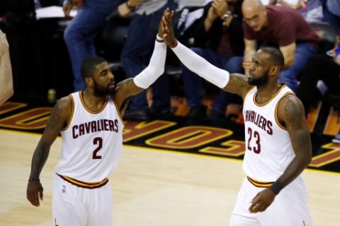 CLEVELAND, OH - JUNE 09: Kyrie Irving #2 and LeBron James #23 of the Cleveland Cavaliers high five against the Golden State Warriors in Game 4 of the 2017 NBA Finals at Quicken Loans Arena on June 9, 2017 in Cleveland, Ohio. NOTE TO USER: User expressly acknowledges and agrees that, by downloading and or using this photograph, User is consenting to the terms and conditions of the Getty Images License Agreement. Gregory Shamus/Getty Images/AFP
