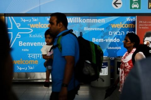 NEW YORK, NY - JUNE 26: People walk through international arrivals at terminal four at John F. Kennedy (JFK) airport following an announcment by the Supreme Court that it will take President Donald Trump's travel ban case later in the year on June 26, 2017 in New York City. The court will let a limited version of the travel ban from six mostly muslim countries take effect before hearing full arguments in October. Spencer Platt/Getty Images/AFP