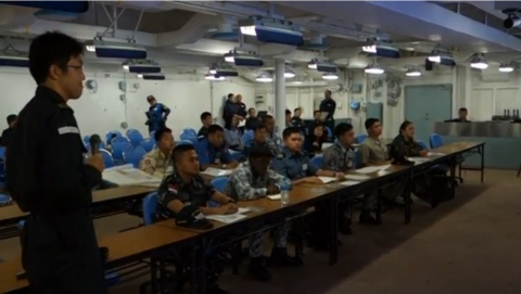 ASEAN military officers listening to Japanese Navy personnel explaining the features of the Japanese war ship, the Izumo. (Photo grabbed from Reuters video) 