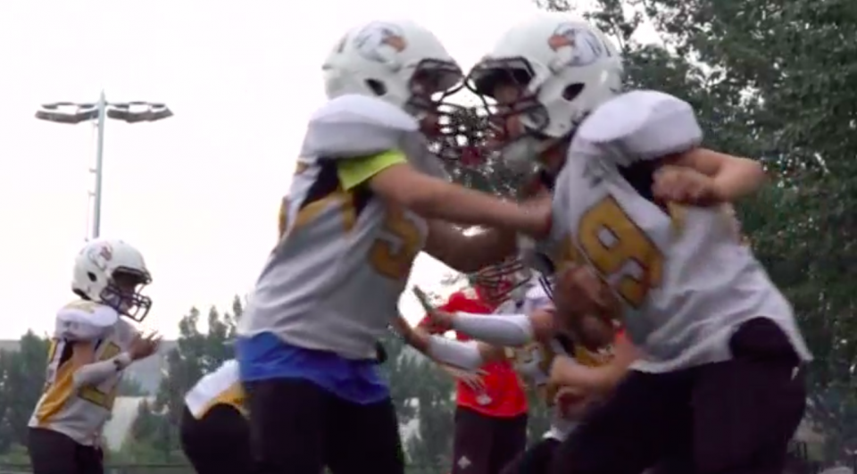 Working together as a team, self-sacrifice and character building is what attracted these parents to enroll their kids in China's first American football youth league. Photo grabbed from Reuters video file.