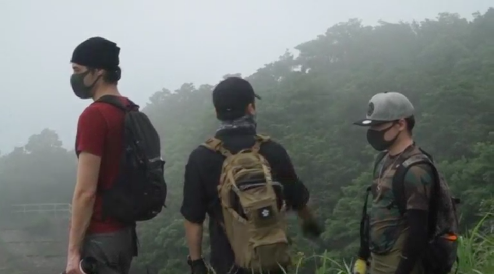 Atop Hong Kong's tallest peak blanketed in clouds, three masked urban explorers took a step back in time as they climbed through a hole in a wire mesh fence, climbed down a hill and marched towards an abandoned army barracks built during British colonial times, likely used during World War Two. Photo grabbed from Reuters video file.