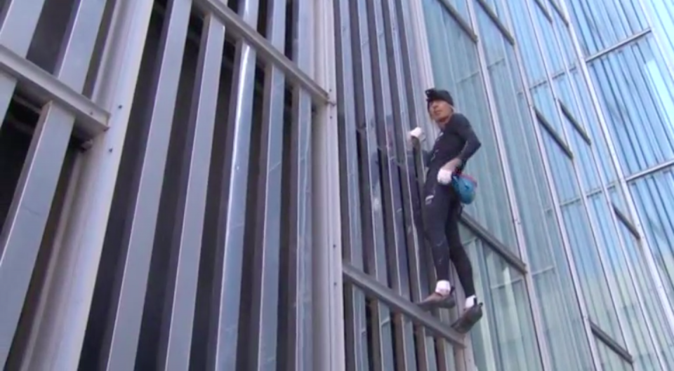 French "Spiderman" Alain Robert scaled one of the tallest skyscrapers in Barcelona without a harness on Monday. Photo grabbed from Reuters video file.