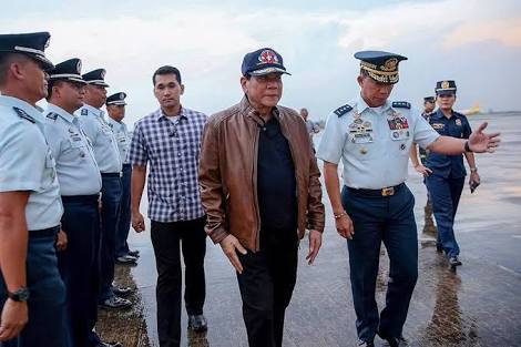 In this photo released by Malacañang, President Rodrigo Duterte is seen walking along a coastline. The Palace said this was taken at Villamor Airbase in Pasay on Thursday, June 15.