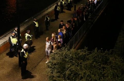 Police officers stand with people evacuated from the area after an incident near London Bridge. REUTERS/Neil Hall