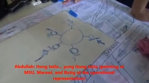 A video grab of the footage found on a mobile phone showing Islamist militants sketching and planning the siege of Marawi and what is needed to be done to establish a caliphate in Mindanao, along with other Islamist militants.  The military got hold of the video that proved the Islamist militants had long been planning the Marawi take-over.  (Photo grabbed from Reuters provided video)